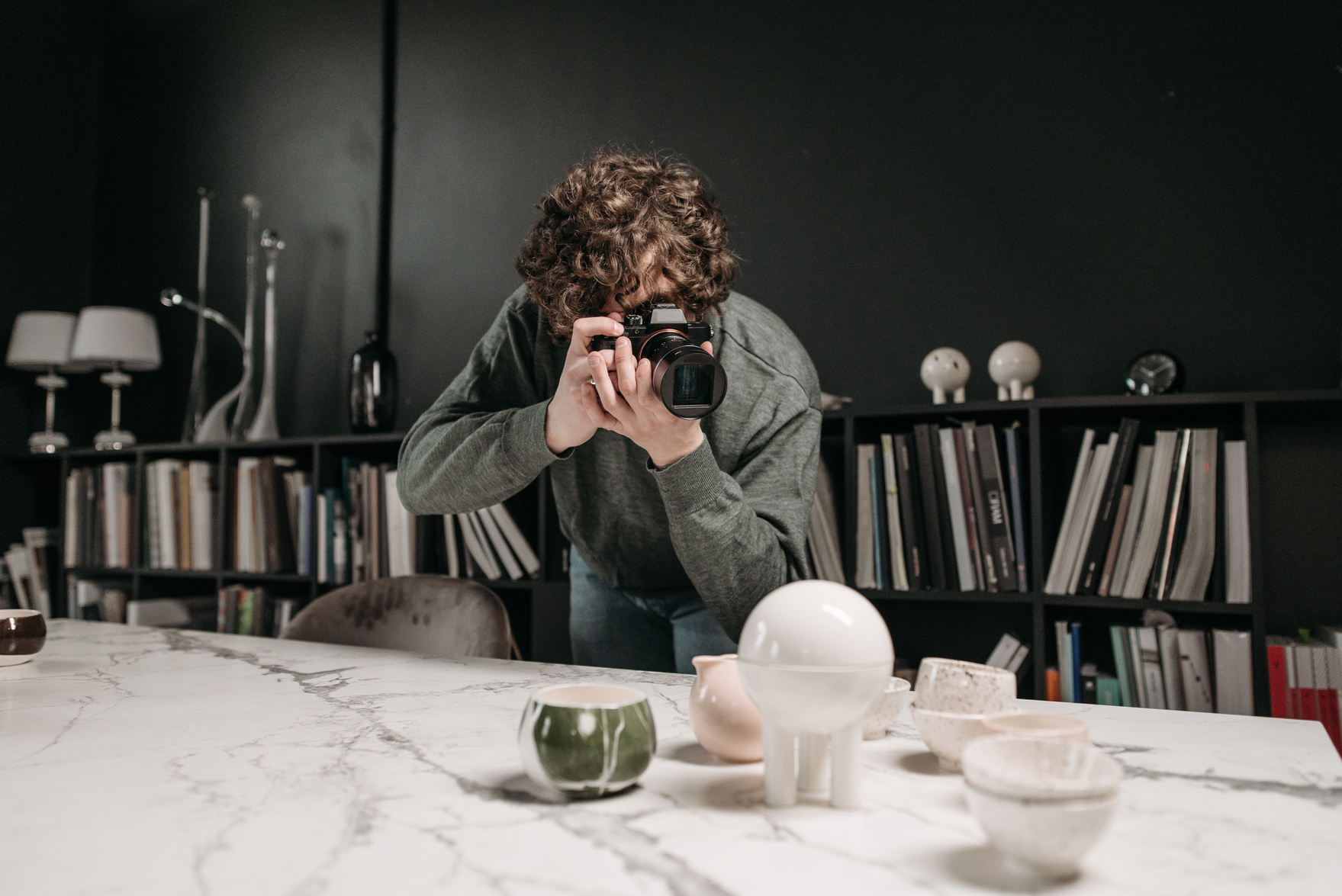 A Photographer Taking Photo of Ceramic Products